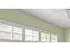 Bedroom with bright windows featuring shutters, a ceiling fan, and green-painted walls at 7615 4Th Avenue Nw Dr, Bradenton, FL 34209