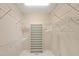 Walk-in closet featuring wire shelving, built-in shoe rack, and tiled flooring providing ample storage space at 7615 4Th Avenue Nw Dr, Bradenton, FL 34209