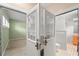 Hallway featuring white french doors, green paint, and a bathroom for privacy and convenience at 7615 4Th Avenue Nw Dr, Bradenton, FL 34209