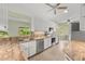 Bright kitchen featuring granite countertops, white cabinets, and stainless steel appliances at 7615 4Th Avenue Nw Dr, Bradenton, FL 34209