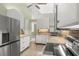 Bright kitchen featuring granite countertops, white cabinets, and stainless steel appliances at 7615 4Th Avenue Nw Dr, Bradenton, FL 34209