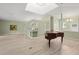 Bright living area with sleek floors, piano, and natural light from a unique skylight at 7615 4Th Avenue Nw Dr, Bradenton, FL 34209