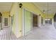 Spacious screened-in porch offering sliding glass doors, ceiling fans, and backyard access at 7615 4Th Avenue Nw Dr, Bradenton, FL 34209