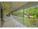 Inviting screened-in porch boasting scenic backyard views, mature trees, and a tranquil pond for relaxation at 7615 4Th Avenue Nw Dr, Bradenton, FL 34209