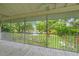 Screened-in porch showcasing a tranquil backyard with lush landscaping, a peaceful pond, and verdant lawn at 7615 4Th Avenue Nw Dr, Bradenton, FL 34209