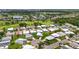 Community aerial shot featuring lush landscaping, a golf course, and lake views in a serene neighborhood at 8470 Imperial Cir, Palmetto, FL 34221