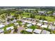 Aerial view of a charming neighborhood, highlighting a peaceful lake and well-manicured lawns at 8470 Imperial Cir, Palmetto, FL 34221