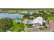 Serene aerial view showcases the clubhouse pool, spa, manicured landscaping, and tranquil lake at 8470 Imperial Cir, Palmetto, FL 34221