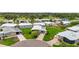 Aerial view of a well-maintained home with green lawns, mature landscaping, and nearby golf course at 8470 Imperial Cir, Palmetto, FL 34221
