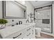 Bright bathroom features a shower, a toilet, a sink, framed mirror, and modern finishes at 8470 Imperial Cir, Palmetto, FL 34221