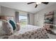 This bedroom features a ceiling fan, carpeted floor, bedside tables with lamps, and a view to the outside at 8470 Imperial Cir, Palmetto, FL 34221