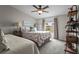 This bedroom features two beds, a ceiling fan, carpeted floor, and bedside tables with lamps at 8470 Imperial Cir, Palmetto, FL 34221