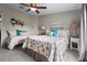 This bedroom features two beds, a ceiling fan, carpeted floor, and bedside tables with lamps at 8470 Imperial Cir, Palmetto, FL 34221