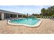 Sparkling community pool with a spacious patio and ample seating for residents to enjoy at 8470 Imperial Cir, Palmetto, FL 34221