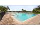Community pool with lounge chairs and tropical landscaping, offering a resort-style living experience at 8470 Imperial Cir, Palmetto, FL 34221