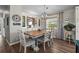 Charming dining area with a wooden table, six chairs, built-in cabinets, and a modern light at 8470 Imperial Cir, Palmetto, FL 34221