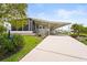 Charming single-story home featuring a covered carport, screened-in porch, and well-maintained landscaping at 8470 Imperial Cir, Palmetto, FL 34221