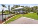 View of the community guard house featuring a gated entrance, landscaping, and well-maintained grounds at 8470 Imperial Cir, Palmetto, FL 34221