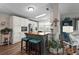 This eat-in kitchen has a center island with seating, white cabinetry, and stainless steel appliances at 8470 Imperial Cir, Palmetto, FL 34221