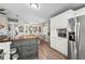 Kitchen featuring stainless steel appliances, white cabinetry and a center island that flows into dining area at 8470 Imperial Cir, Palmetto, FL 34221