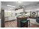 Bright kitchen featuring white cabinetry, laminate flooring, a center island and is open to the living room at 8470 Imperial Cir, Palmetto, FL 34221