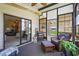 Enclosed lanai with wicker furniture, offering views and access to the home's interior at 8470 Imperial Cir, Palmetto, FL 34221