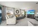 Comfortable living room featuring modern furniture, a decorative mirror, and a flat screen television at 8470 Imperial Cir, Palmetto, FL 34221