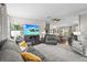 Open-concept living room with a flat-screen TV, comfortable seating, and a view of the dining area at 8470 Imperial Cir, Palmetto, FL 34221