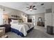 This primary bedroom features a ceiling fan, carpeted floor, bedside tables with lamps, and ensuite bathroom at 8470 Imperial Cir, Palmetto, FL 34221