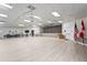 Large meeting room with stage, neutral paint, wood floors, and abundant lighting for social gatherings at 8470 Imperial Cir, Palmetto, FL 34221