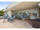Relaxing outdoor lounge with seating, tables, and a view of the surrounding landscaping at 8470 Imperial Cir, Palmetto, FL 34221