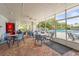 Shaded patio area overlooking a pool offers comfortable seating for dining and relaxing at 8470 Imperial Cir, Palmetto, FL 34221