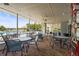 Covered outdoor patio with tables, chairs, and views of the sparkling community pool at 8470 Imperial Cir, Palmetto, FL 34221