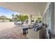 Comfortable poolside seating with wicker furniture and a view of the pool and surrounding greenery at 8470 Imperial Cir, Palmetto, FL 34221