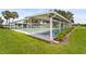 Exterior shot of covered shuffleboard courts, lush lawn, seating, and palm trees enhance this community's appeal at 8470 Imperial Cir, Palmetto, FL 34221