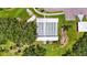 Overhead view of a covered shuffleboard court with trees, landscaping and parking at 8470 Imperial Cir, Palmetto, FL 34221