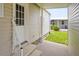 Exterior view of the side entrance with well maintained landscaping and a covered porch at 8470 Imperial Cir, Palmetto, FL 34221