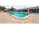 Inviting swimming pool surrounded by a large patio, lounge chairs, and lush landscaping at 8470 Imperial Cir, Palmetto, FL 34221