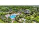 Aerial view showcasing the community clubhouse, pool, and surrounding green spaces, perfect for relaxation and recreation at 8827 Manor Loop # 208, Lakewood Ranch, FL 34202