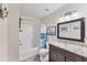 Cozy bathroom featuring a vanity with granite countertops, mirror, shower, and a bathtub at 8827 Manor Loop # 208, Lakewood Ranch, FL 34202