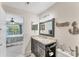 Bathroom with a granite countertop vanity, large mirror, and view of the adjacent bedroom at 8827 Manor Loop # 208, Lakewood Ranch, FL 34202