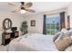 Bright bedroom with a ceiling fan, serene water view from the window, and a cozy bed at 8827 Manor Loop # 208, Lakewood Ranch, FL 34202