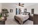 Bedroom with a ceiling fan, calm view from the window, and a cozy bed with patterned bedding at 8827 Manor Loop # 208, Lakewood Ranch, FL 34202