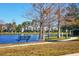 Relaxing view of the community pond with bench seating and sidewalk that winds past the nearby townhomes at 8827 Manor Loop # 208, Lakewood Ranch, FL 34202