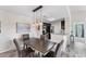 Dining room featuring modern light fixture and seating for four with an open floor plan to the kitchen at 8827 Manor Loop # 208, Lakewood Ranch, FL 34202