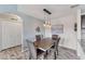 The dining room features modern lighting and is conveniently located near a laundry closet at 8827 Manor Loop # 208, Lakewood Ranch, FL 34202