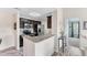 Well-equipped kitchen featuring granite countertops, stainless steel appliances, and wood-look tile flooring at 8827 Manor Loop # 208, Lakewood Ranch, FL 34202