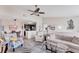 Comfortable living room adjacent to dining room and kitchen, featuring stylish decor and an open layout at 8827 Manor Loop # 208, Lakewood Ranch, FL 34202