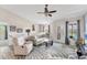 Cozy living room with comfortable seating, scenic view, and stylish ceiling fan at 8827 Manor Loop # 208, Lakewood Ranch, FL 34202