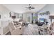 Bright living room features modern decor, fan, and a sliding glass door with a scenic view at 8827 Manor Loop # 208, Lakewood Ranch, FL 34202